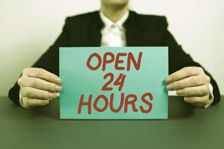 Conceptual display Open 24 Hours. Business idea Working all day everyday business store always operating Businesswoman Holding Note With Important Message On Office Desk.の写真素材