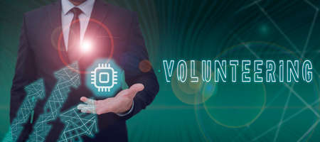 Sign displaying Volunteering. Concept meaning Provide services for no financial gain Willingly...