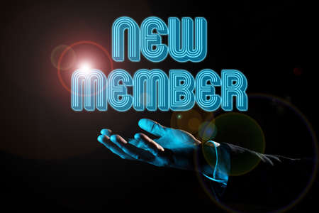 Text sign showing New Member. Word for recruiting employee to company or team Birth of fresh child Businessman Holding And Presenting Important Informations On Hand.の写真素材