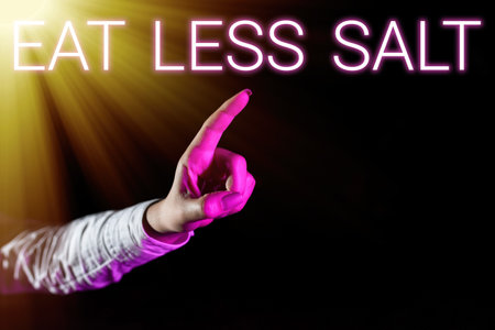 Sign displaying Eat Less Salt. Word Written on Reduce the amount of sodium in your diet eating...