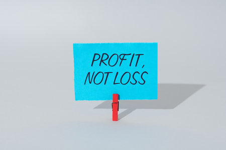 Sign displaying Profit Not Loss. Internet Concept Just revenues good economic strategy successful finances Businessman in suit holding notepad symbolizing successful teamwork.の写真素材