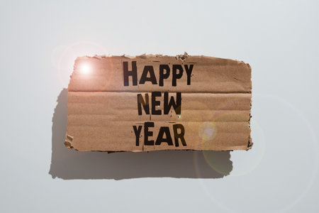 Text sign showing Happy New Year. Conceptual photo Greeting Celebrating Holiday Fresh Start Best wishes Paper Wraps Placed Around Speech Bubble With Important Information.の写真素材