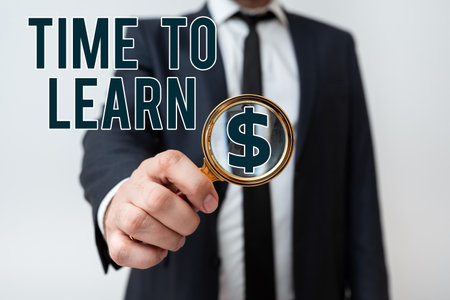 Writing displaying text Time To Learn. Word for Obtain new knowledge or skill Educational or career growth Businessman in suit holding tablet symbolizing successful teamwork.の写真素材