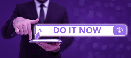 Text showing inspiration Do It Now. Conceptual photo Respond Immediately Something needs to be done right away Businessman in suit holding tablet symbolizing successful teamwork.の写真素材