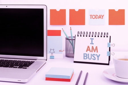 Hand writing sign I Am Busy. Business concept To have a lot of work to do Stressed out no time for leisure Woman Holding Pen On Desk With Paperwraps And Note With Important Data.の写真素材