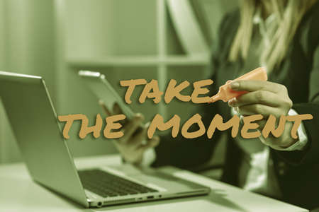 Writing displaying text Take The Moment. Word for Seize the day and opportunity be happy optimistic positive Hands Holding Lamp Rocket With Businessman Presenting New Ideas Startupsの写真素材