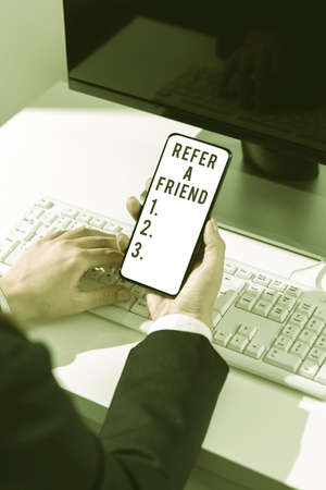 Conceptual caption Refer A Friend. Business showcase Recommendation Appoint someone qualified for the task Man With Hand Displaying S And Glowing Lines In Futuristic Frame.の写真素材