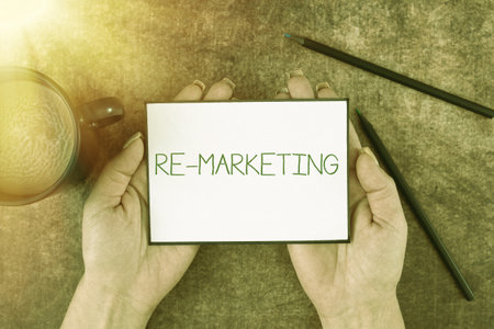 Hand writing sign Re Marketing. Concept meaning Strategy to reach potential customers in your websiteの写真素材