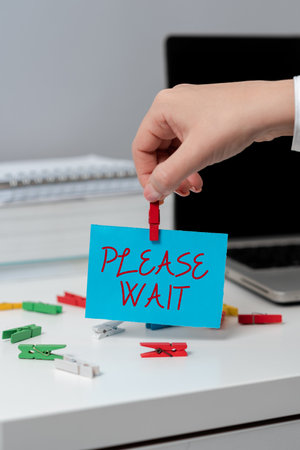 Text sign showing Please Wait. Word for to pause any implemented action immediately and hold onの写真素材