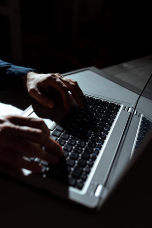 Businessman Typing Recent Updates On Lap Top Keyboard On Desk. Man In Office Writing Important Message On Computer. Executive Inserting Crutial Data Into Pc.の写真素材