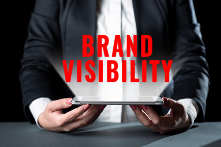 Text sign showing Brand Visibility. Business showcase dividing the cost of something into the different parts Businesswoman Holding Cellphone And Presenting Important Informations.の写真素材