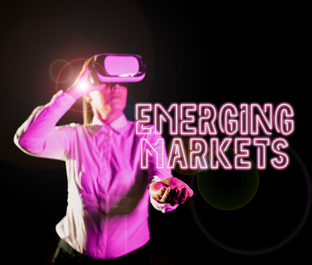 Hand writing sign Emerging Markets. Conceptual photo nations that are investing in more productive capacity Woman Taking Professional Training Through Virtual Reality Goggles.の写真素材