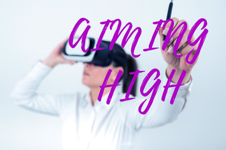 Sign displaying Aiming High. Business approach a result that your plans or actions are intended to achieveの写真素材