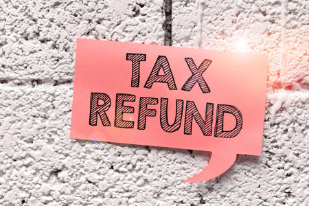 Sign displaying Tax Refund. Conceptual photo applied when money liability is less than the paid onesの写真素材