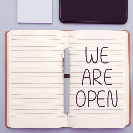 Text caption presenting We Are Open. Word for no enclosing or confining barrier, accessible on all sidesの写真素材