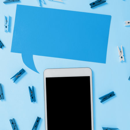 Important Message Presented On Phone On Desk With lothespins, Paper. Crutial Information Shown On Cellphone Screen Placed On Table. New Ideas On Mobile Phone.の写真素材