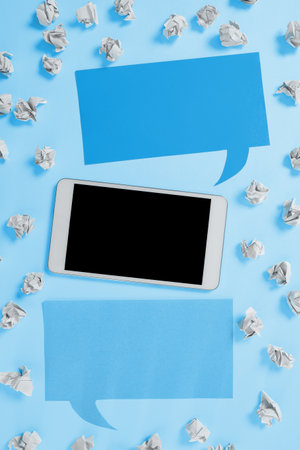 Important Message Presented On Phone On Desk With Paperwraps, Paper. Crutial Information Shown On Cellphone Screen Placed On Table. New Ideas On Mobile Phone.の写真素材