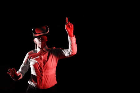 Woman Wearing Vr Glasses And Pointing On Important Messages With One Finger. Businesswoman Having Virtual Reality Eyeglasses And Showing Crutial Informations.の写真素材