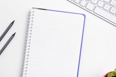 Colored paper with important message lying desk near keyboard. Main information written on notebook. School supplies. Multiple Assorted Collection Office Stationery.の写真素材