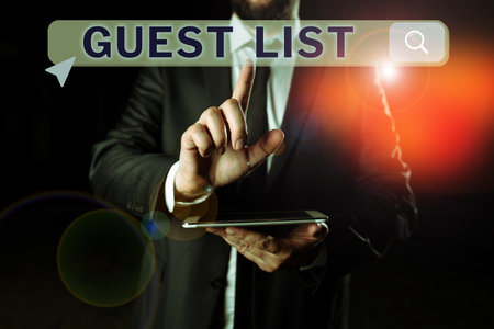 Hand writing sign Guest List. Business idea a list of people who are allowed to enter the show or an eventの写真素材