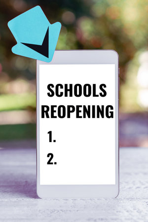 Sign displaying Schools Reopening. Concept meaning classes are over for the time being End of the school dayの写真素材