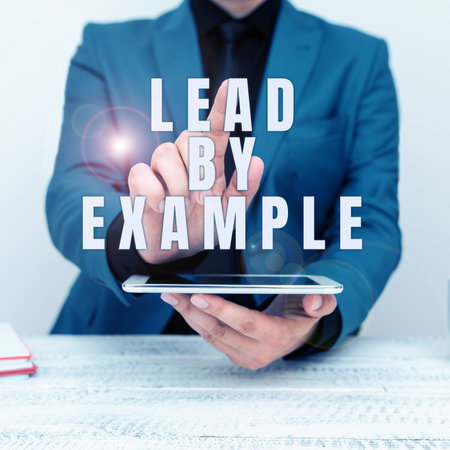 Text caption presenting Lead By Example. Business idea Be a mentor leader follow the rules give examples Coachの写真素材