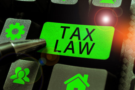 Writing displaying text Tax Law. Word for governmental assessment upon property value or transactionsの写真素材