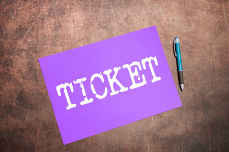 Sign displaying Ticket. Word for piece of paper card that gives holder certain right entering placeの写真素材