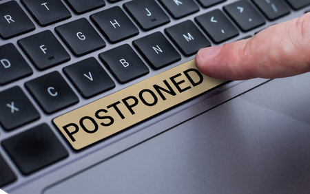 Hand writing sign Postponed. Business idea to place later in order of precedence, preference, or importanceの写真素材