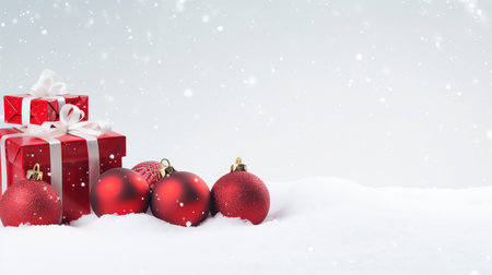 Panoramic image of gift box and red christmas balls on snow, copy spaceの素材
