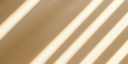 Diagonal window light creates interesting shadows on a beige wall, adding depth and texture Perfect for use in interior design and artistic backgrounds.の素材
