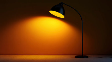 Modern black floor lamp with curved arm illuminates blank wall with warm glow Use for interior design or product showcase presentations.の素材