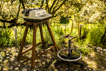 typewriter and old chair in natureの写真素材