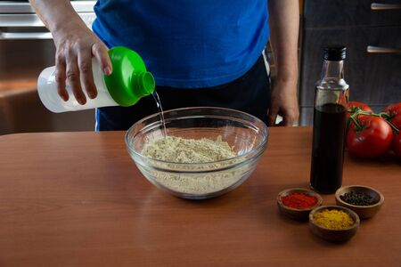 Mature woman doing the seitan cooking process at home. How to prepare seitan at home vegan meatの写真素材