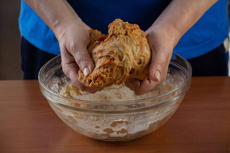 Mature woman doing the seitan cooking process at home. How to prepare seitan at home vegan meatの写真素材