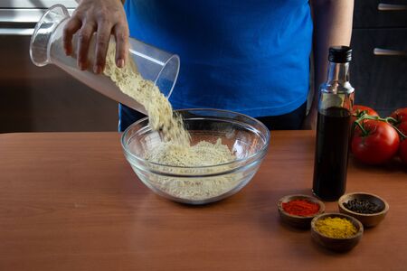 Mature woman doing the seitan cooking process at home. How to prepare seitan at home vegan meatの写真素材
