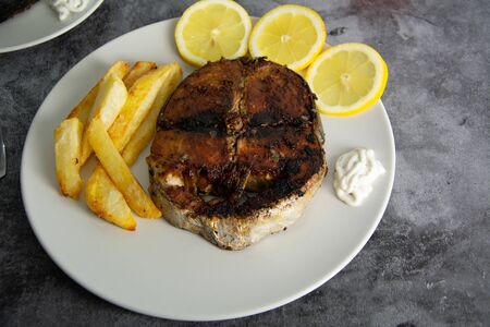 Grilled tuna seasoned with lemon, garlic and potatoes. Healthy foodの写真素材