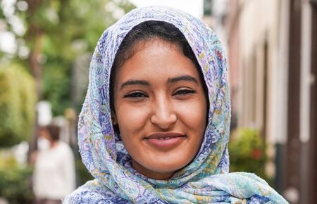 Muslim woman smiling in front on phone camera - Arabian girl having fun outdoor - Different...