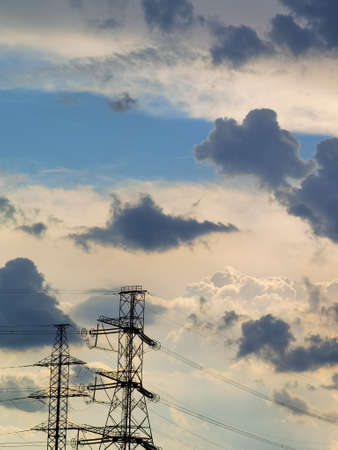 High voltage power lines under blue cloudy sky with plenty of room for copy and textの写真素材