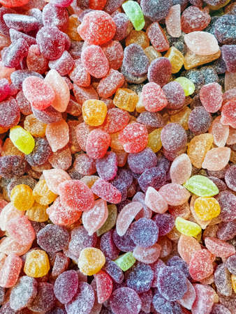 Fun colorful soft candy background. Closeup of sugar coated gelÃ©e sweets filling up the full frame with yellow, purple and red.の写真素材