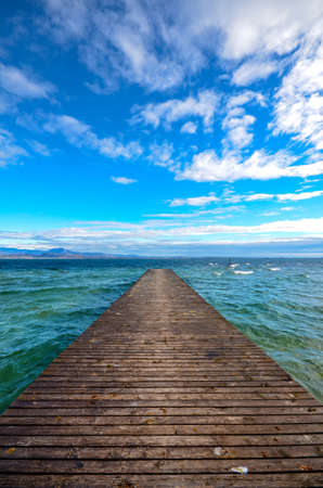 Wooden Pier Jutting Out into lake surrounded by mountain - Vertical (Portrait) orientationの写真素材