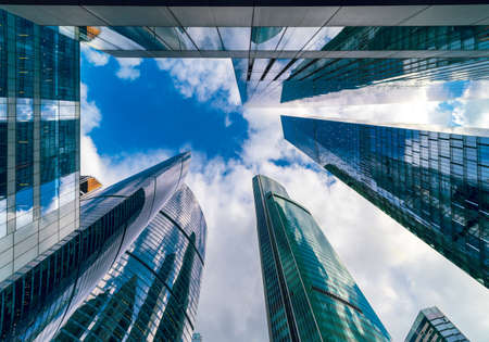 Towering skyscrapers in the business and finance district of Moscow City in the Russian Capital, seen from below against the sky look like a forest of buildings and represent Russia's economic powerの写真素材