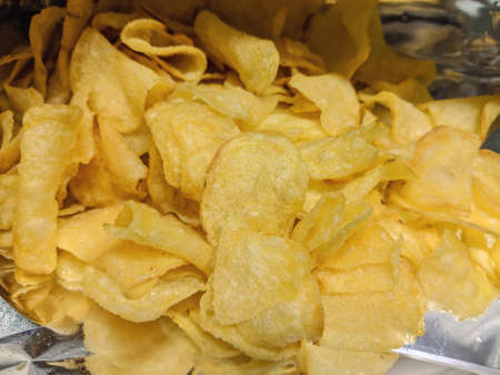 Close-up of potato Chips or crips in their open bag