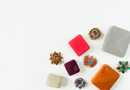 Woman's Jewelry. Vintage jewelry background. Beautiful bright rhinestone brooches and jewelry boxes...