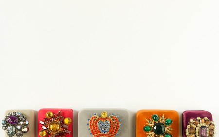 Woman's Jewelry. Vintage jewelry background. Beautiful bright rhinestone brooches and jewelry boxes...