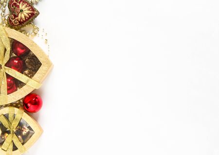 Christmas background. Christmas gift gold boxes and red balls on white background. Top view with copy space.の写真素材