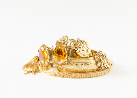 Womans Jewelry. Vintage jewelry background. Beautiful bright rhinestone brooches, braceletes, necklace and earrings on white.の写真素材