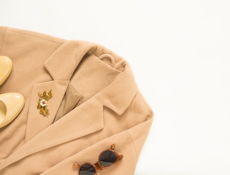 Spring, autumn female outfit. Set of clothes, shoes and accessories on white background. Camel coat and cream shoes.の写真素材