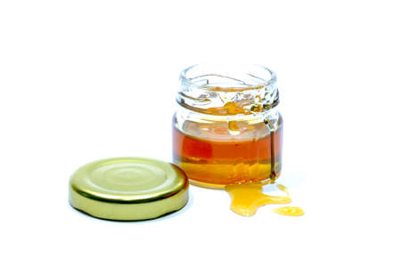 Honey in a glass bottle White background