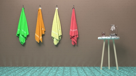 Fitness club, massage salon, luxury pool or a spa scene - four colorful, soft towels hanging on a brick-like brown wall, a glass of water and a jar on a stylish table wood and marble tableの写真素材